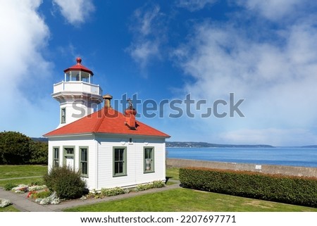Mukilteo Lighthouse on a sunny day. The lighthouse is an operational navigation aid located on the east side of Possession Sound at Mukilteo, Snohomish County, Washington. Royalty-Free Stock Photo #2207697771