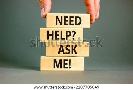 Support and need help ask me symbol. Concept words Need help ask me on wooden blocks on a beautiful grey table grey background. Businessman hand. Business, support and Need help ask me concept.
