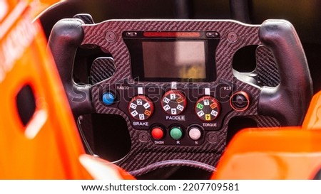 Racing car steering wheel.  Detailed view of an open-wheel single-seater formula racing car. Royalty-Free Stock Photo #2207709581