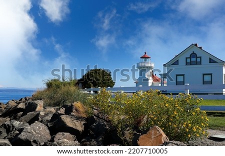 Mukilteo Lighthouse on a sunny day. The lighthouse is an operational navigation aid located on the east side of Possession Sound at Mukilteo, Snohomish County, Washington. Royalty-Free Stock Photo #2207710005
