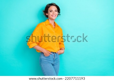 Photo of confident adorable woman bob hairstyle wear yellow blouse denim jeans arms in pockets isolated on turquoise color background Royalty-Free Stock Photo #2207711193
