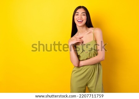 Photo of shiny sweet young girl dressed clothes laughing empty space isolated yellow color background