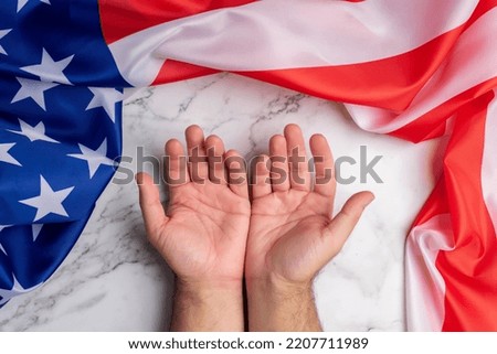 Background with two open hands surrounded by the flag of the United States of America symbolizing the welcome and good reception of this country. Freedom and American dream