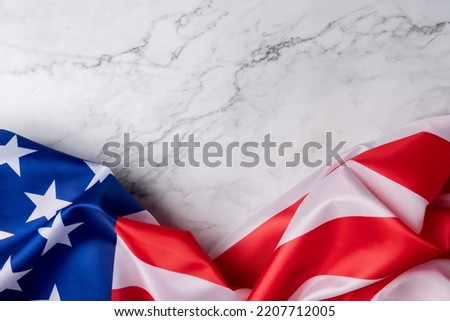 Background with the flag of the united states on a white marble base. American wallpaper to put patriotic or USA related messages