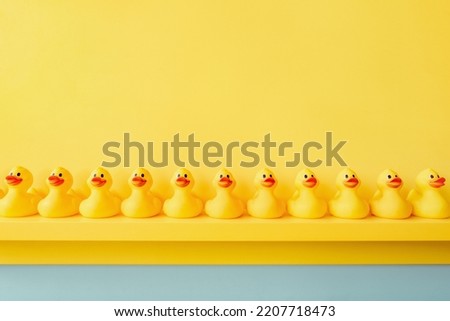 Rubber ducky bath toy background yellow ducks in a row. Rubber duck background team meeting. Yellow rubber duck in a line toy design yellow concept team work together. Community. Teamwork. Cooperation Royalty-Free Stock Photo #2207718473