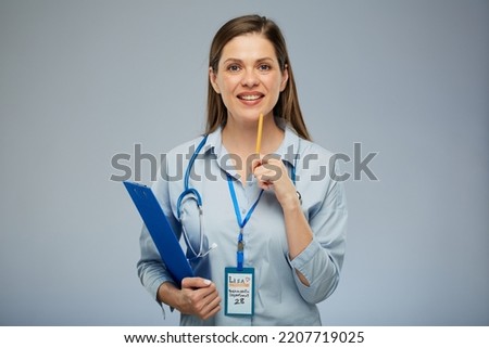 Smiling doctor woman or health Insurance agent holding blue clipboard. Isolated portrait of female medical worker 
