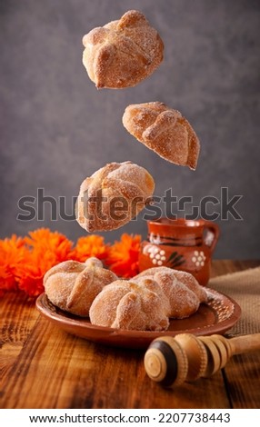 Pan de Muerto. Typical Mexican sweet bread that is consumed in the season of the day of the dead. It is a main element in the altars and offerings in the festivity of the day of the dead. Royalty-Free Stock Photo #2207738443