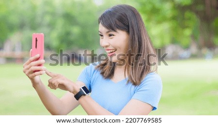 asian young woman take selfie happily with smart phone in the park or campus