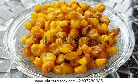 photo of dry cooked corn on blurred background. In Indonesia it is called a marning snack.