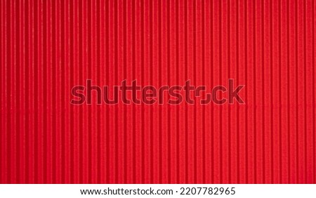 Decorative background. Background texture of corrugated red cardboard.