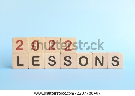 Year 2022 life lessons and learnings concept. Wooden blocks in blue background. Royalty-Free Stock Photo #2207788407