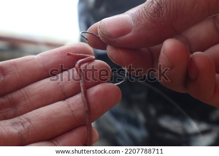 attaching worm bait to the hook