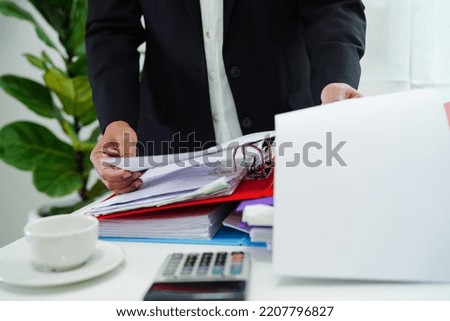 Business woman busy working with documents in office.