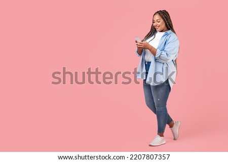 African American Plus Size Female Using Smartphone Texting Standing Posing On Pink Background, Studio Shot. Great Mobile App Concept. Full Length, Copy Space Royalty-Free Stock Photo #2207807357