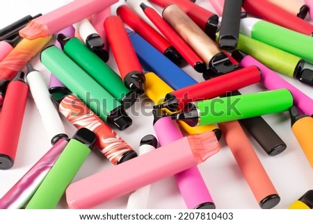 Set of colorful disposable electronic cigarettes of different shapes on a white background. The concept of modern smoking. Royalty-Free Stock Photo #2207810403