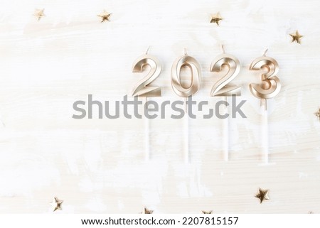 Beautiful festive background with numbers 2023 on a wooden background with copy space. Christmas and New Year holiday card, flat lay.