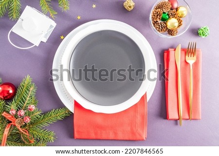 Serving the New Year's table. empty plates and gold cutlery with decorations. Concept image for menu and poster. a festive empty plate