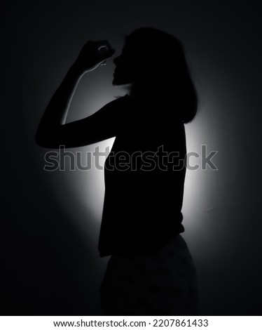 A picture of girl shadow in which the flash light is running behind . Night photography. Girl shadow picture girl thinking