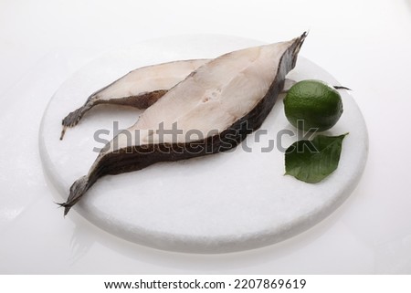 Two halibut slices, steaks on a white background, a packshot photo for fish shop, fishmongers.
