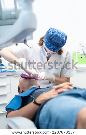 Dental clinic, doctor performing an endodontic operation on a patient