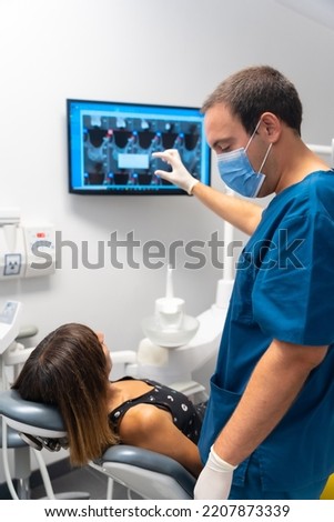 Dental clinic, doctors explaining to the patient saying how her teeth are in the revision