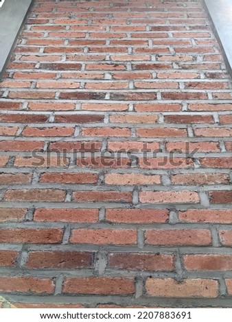 abstract wall texture. the concept of a house wall or fence for home decoration. Minimalist house made of bricks  sandstone. The walls are overgrown with plants, adding a natural  elegant impression