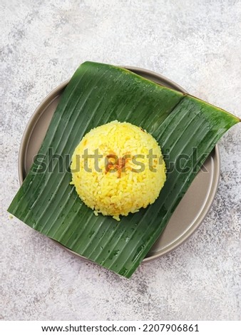 Yellow rice (nasi kuning) is a typical Indonesian food. This dish is made from rice cooked together with turmeric and coconut milk and spices Royalty-Free Stock Photo #2207906861