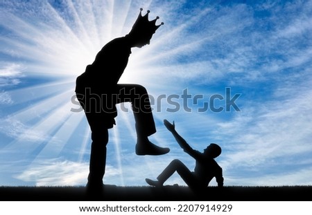 Selfishness. The big man with the crown on his head intends to destroy the little man. The concept of behavior as a selfish tyrant and dictator in business, politics and life. Silhouette Royalty-Free Stock Photo #2207914929