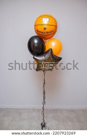 a set of orange balloons, a foil balloon basketball, the inscription on the balloon "Happy Birthday"