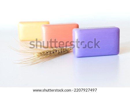 colored bath soaps, ear of wheat. close-up.