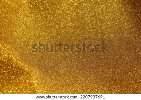 Gold and golden yellow glitter bokeh circle glow  blurred and blur abstract. Glittering shimmer bright luxury . White and silver glisten twinkle for texture wallpaper and background backdrop.
