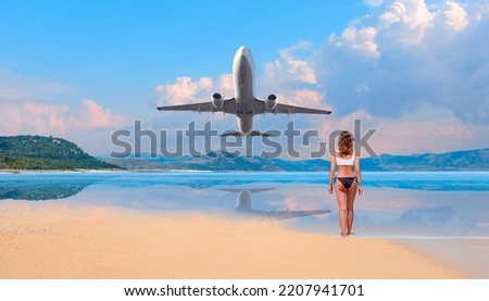Young woman in black and white  bikini on the beach with airplane on background