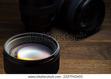 Close up of camera lens on wooden table