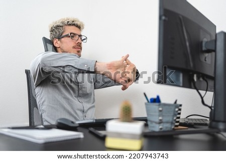 Businessman stretching his hands in the desk of the office. Efficiency at work concept. White background