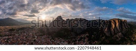 Meteora Greece panorama. Sunset and cloudy sky over Kalabaka town and valley. Rock formations landscape, Europe travel destination 
