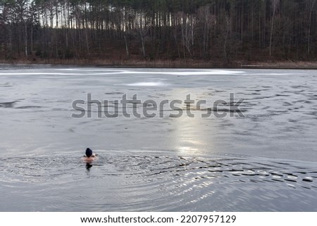 Winter swimming in a partially frozen lake