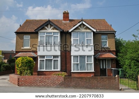 View of 1930s era semidetached houses on a residential street in an English city Royalty-Free Stock Photo #2207970833