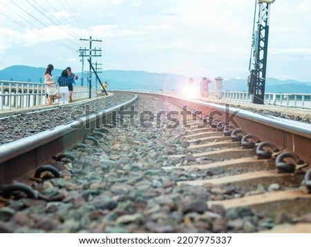 Railroad tracks run on a bridge over a river.