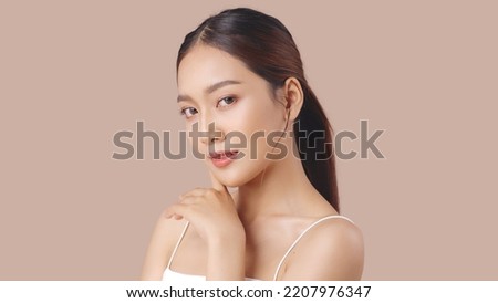 Studio shot of Beautiful young Asian woman with clean fresh skin on brown background, Face care, Facial treatment, Cosmetology, beauty and spa. Royalty-Free Stock Photo #2207976347