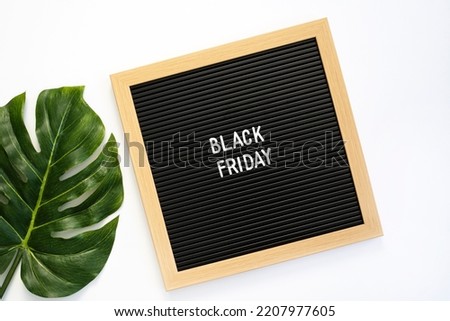 Black friday sign on letter board over white background
