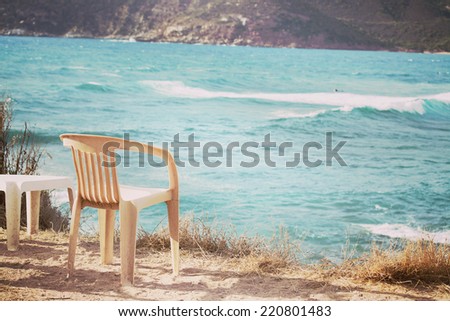 plastic chair by the sea in vintage tone