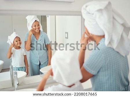 Mother and girl doing skincare in the morning in the bathroom together. Black family in their home doing skincare routine, using products and lotion on their face. Family, face cream and facial care