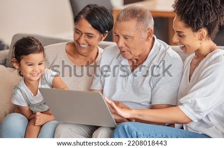 Family, laptop and child watching educational video, movie or cartoon sitting with parent and grandparents on a sofa in their brazil home. Bonding, fun and internet streaming with man, women and kid