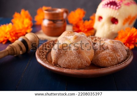 Pan de Muerto. Typical Mexican sweet bread that is consumed in the season of the day of the dead. It is a main element in the altars and offerings in the festivity of the day of the dead. Royalty-Free Stock Photo #2208035397