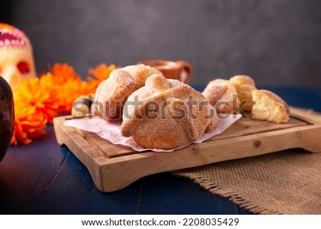 Pan de Muerto. Typical Mexican sweet bread that is consumed in the season of the day of the dead. It is a main element in the altars and offerings in the festivity of the day of the dead. Royalty-Free Stock Photo #2208035429