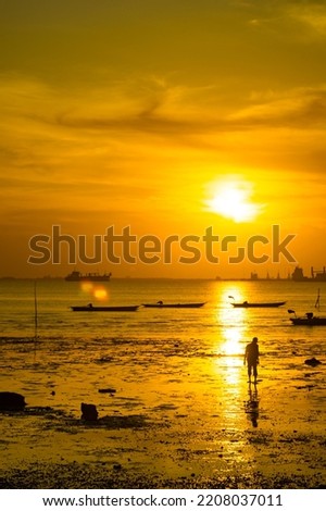 View of beach with some boats during sunset in Bangkalan, Madura, Indonesia