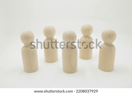 a Shapes of people grouped in solidarity community with simple white background.