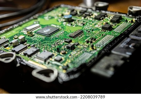Car ecu repair detail. Electronic board repair Royalty-Free Stock Photo #2208039789