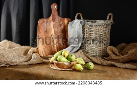 Autumn fruits in a composition on a wooden table in a dark interior and free space