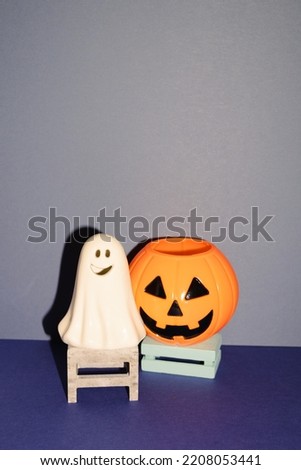 Halloween party decor, ghost and pumpkin on blue background